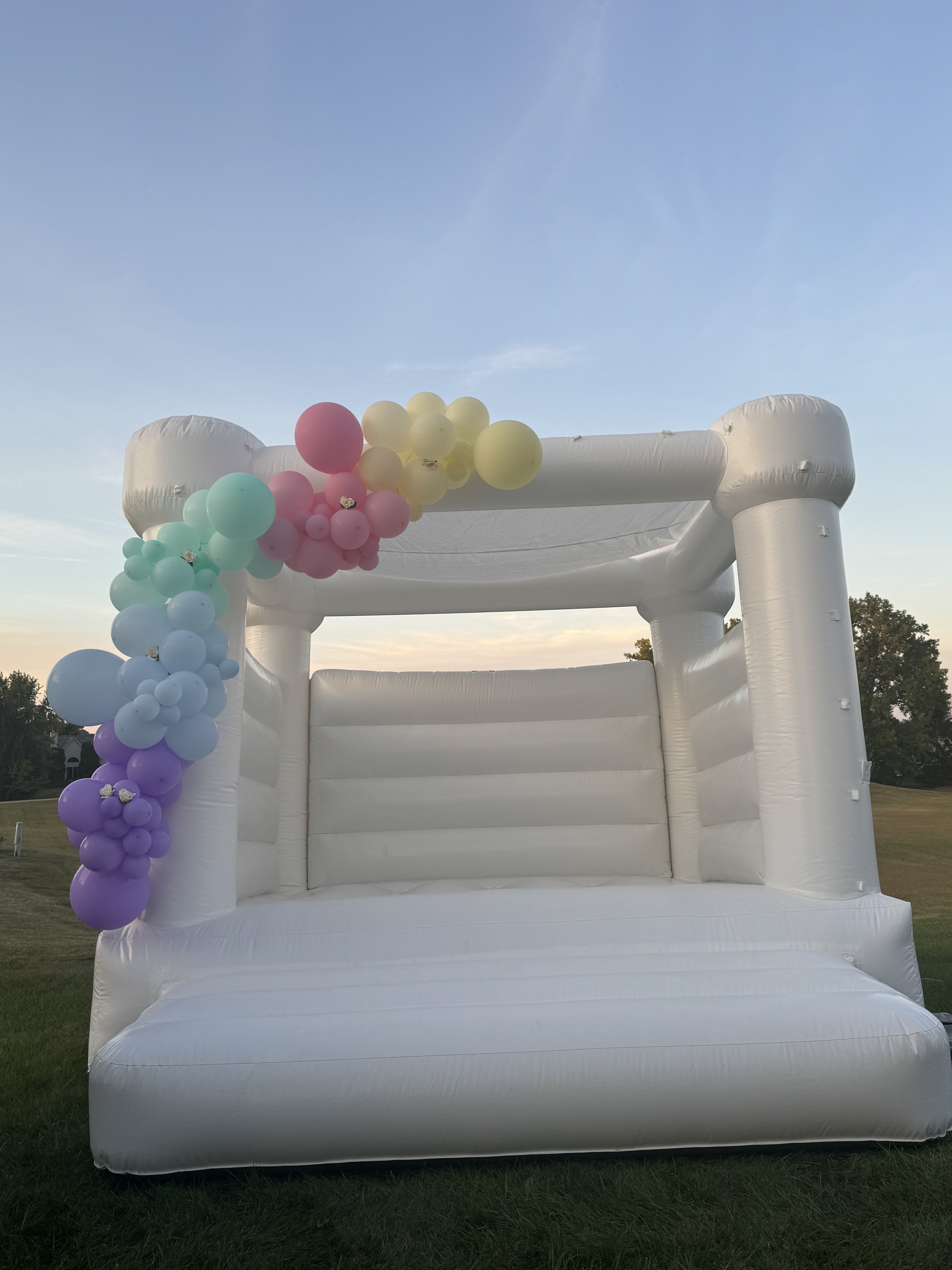 White bounce house rental setup for a backyard party in Fort Wayne Indiana